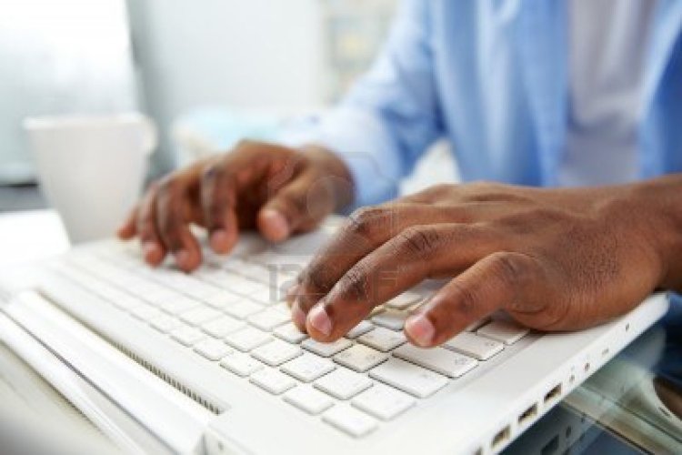 13949199-close-up-of-african-man-typing-on-laptop