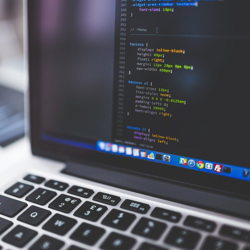 gray laptop computer showing html codes in shallow focus photography